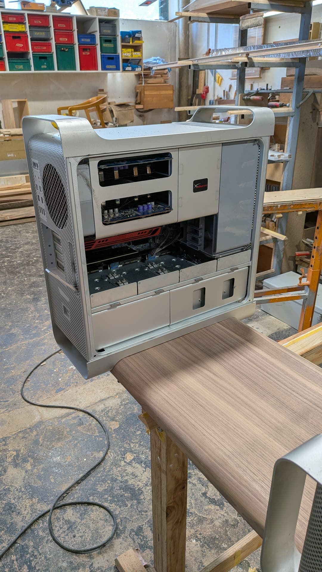 An open aluminium Mac Pro tower enclosure showing its internal bays.